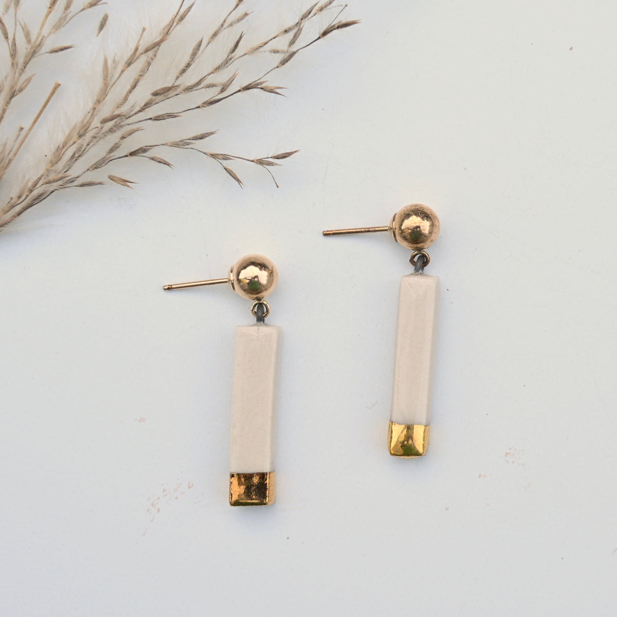 Mira handmade porcelain earrings with modern slender drops and genuine gold luster by Hudson Ceramics.