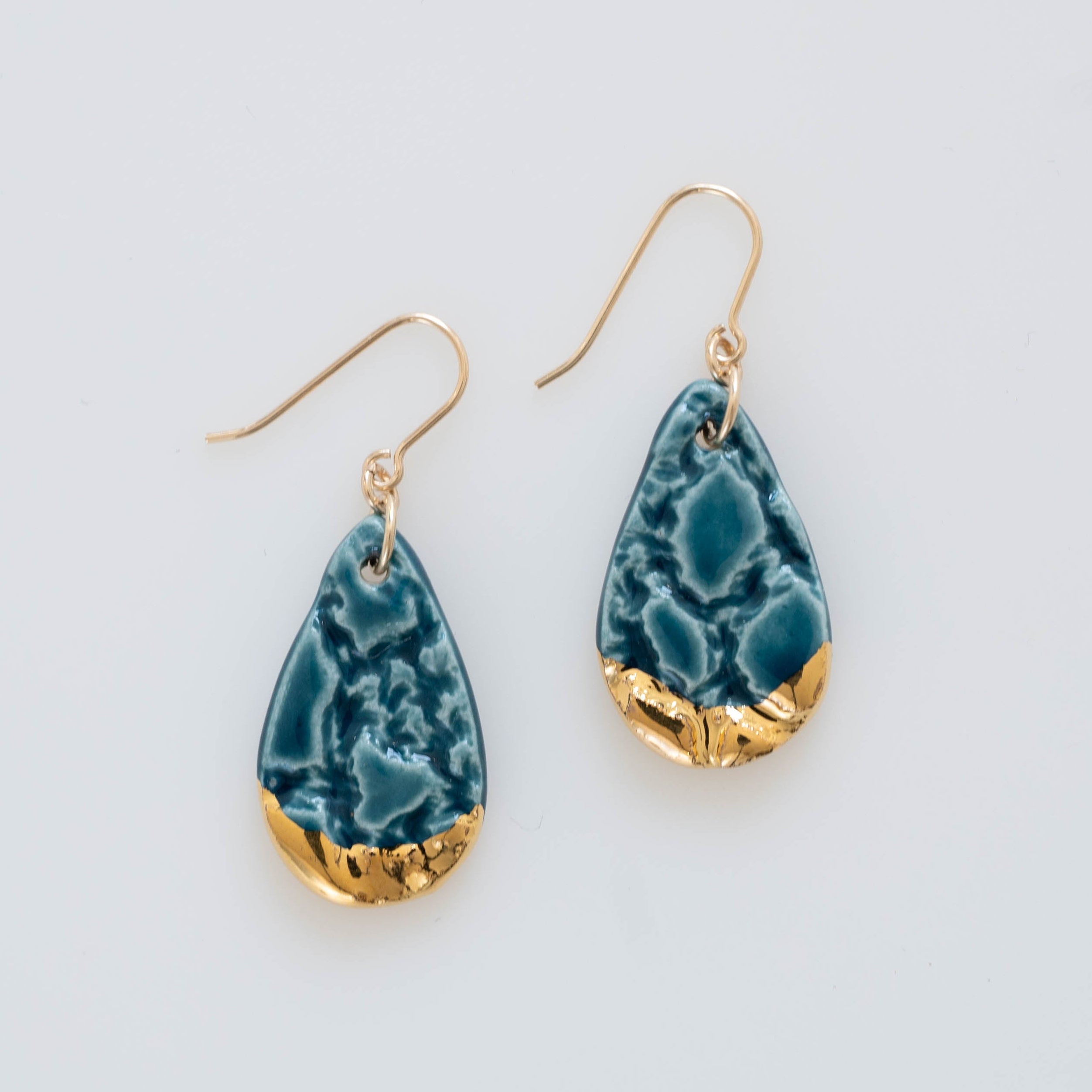 Teardrop shaped dangle earring, teal color with gold accent
