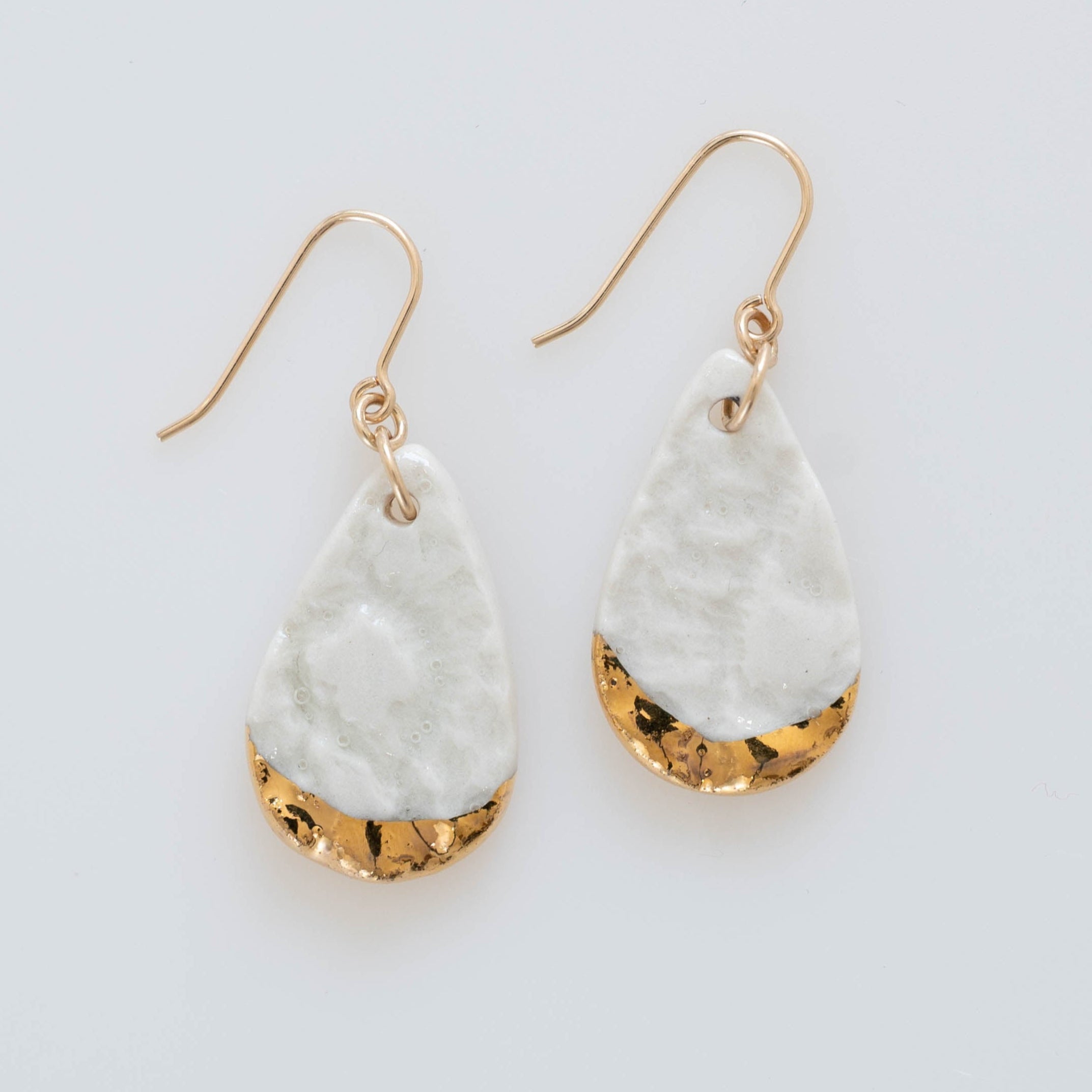 Ivory dangle earrings with gold accents