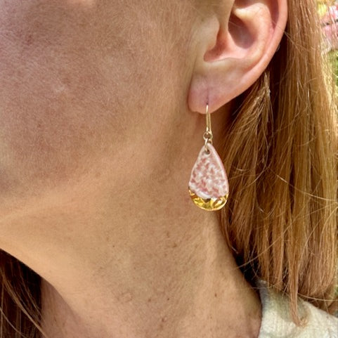Model wearing Pink lace textured porcelain earrings with gold luster by Hudson Ceramics