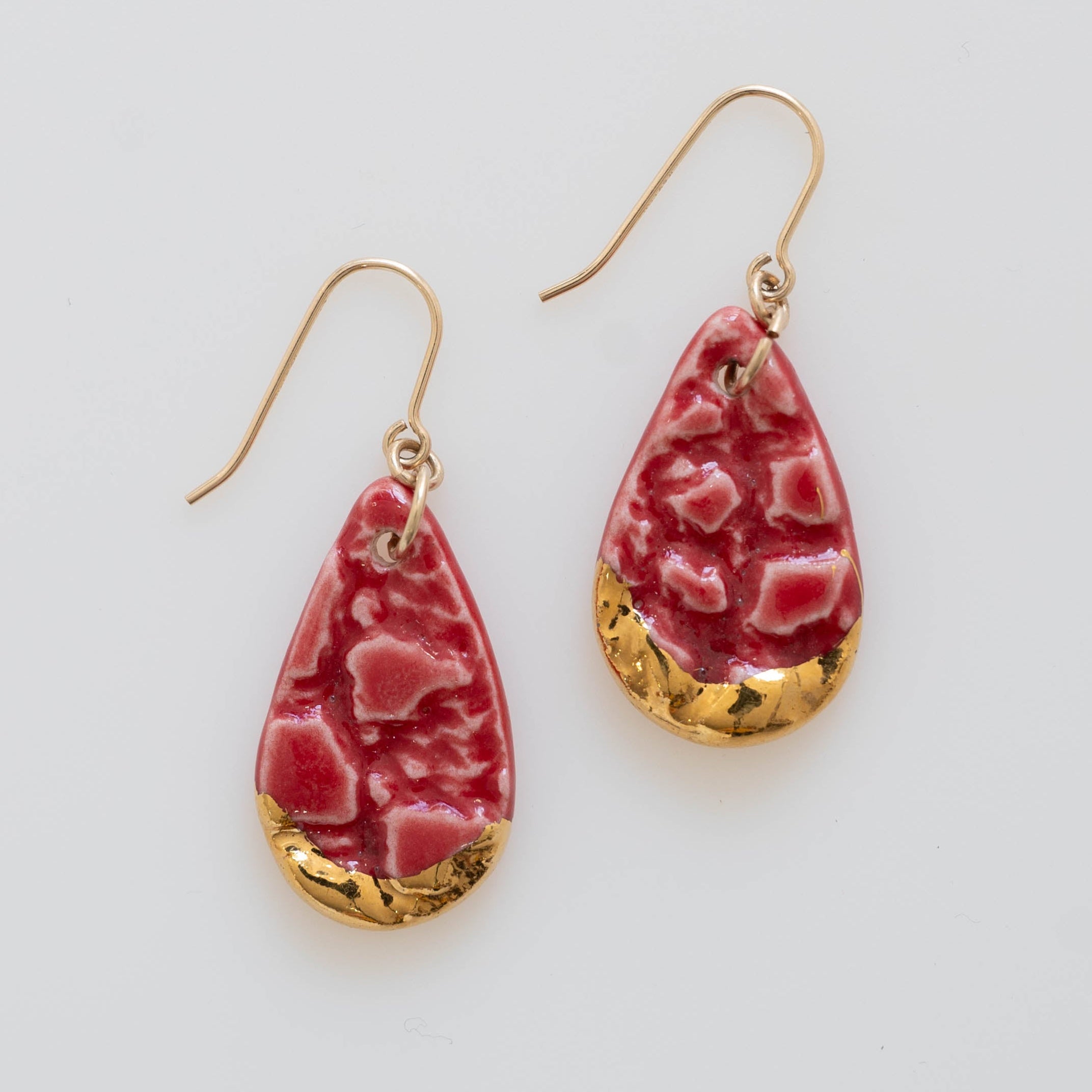 Red dangle earring with gold accents