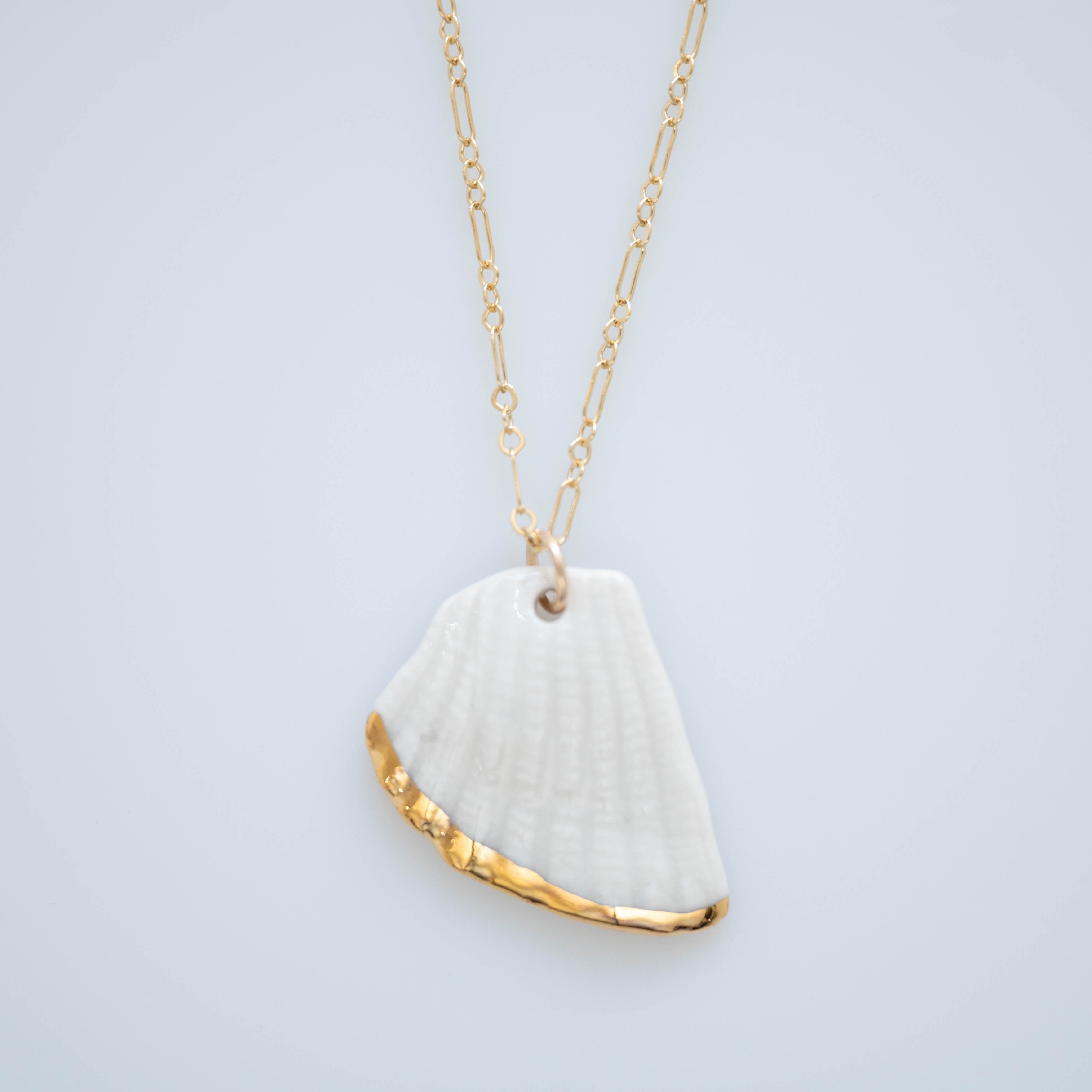 A hand painted porcelain necklace with gold lustre, attached to a gold-filled 18" chain.