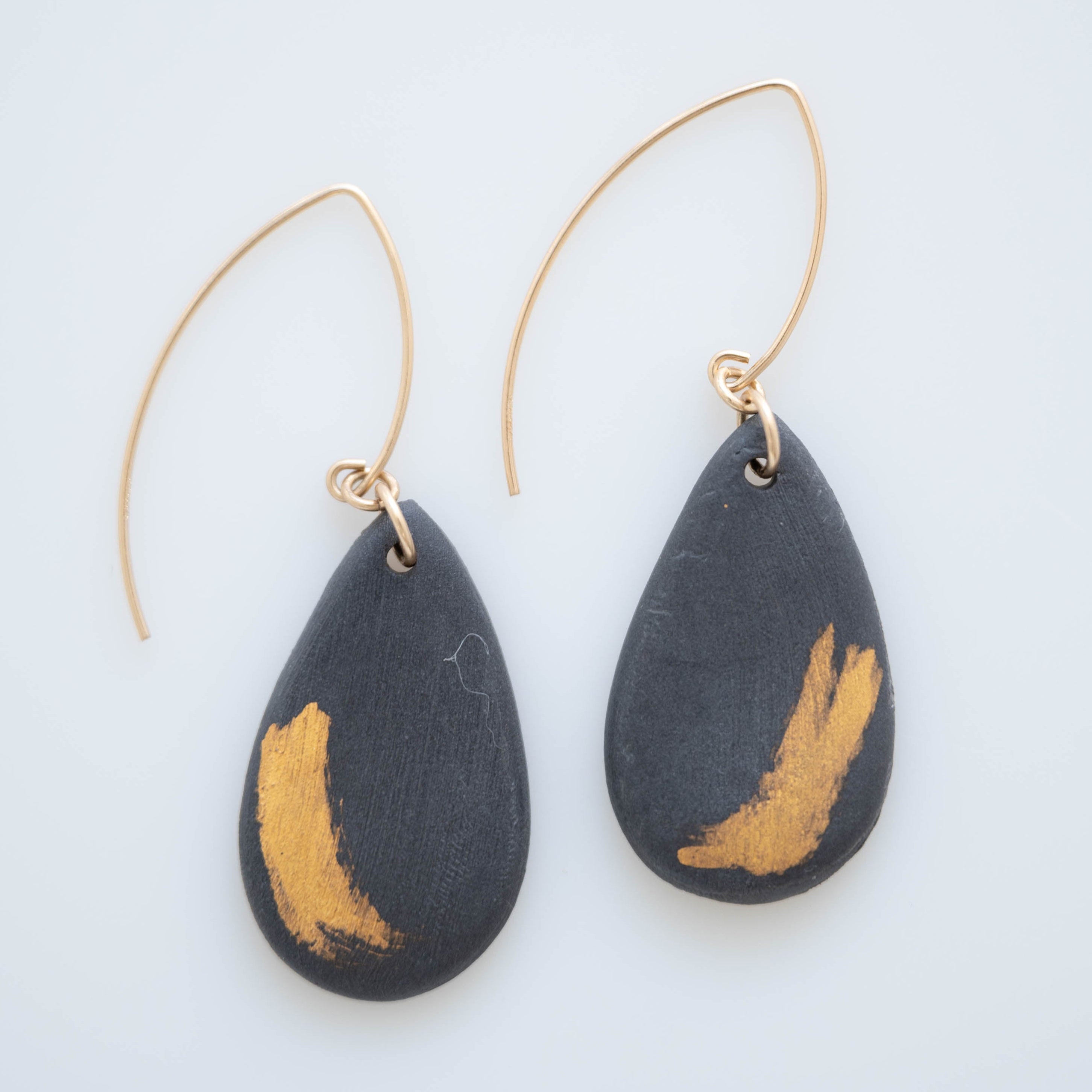Black and gold teardrop shaped earring