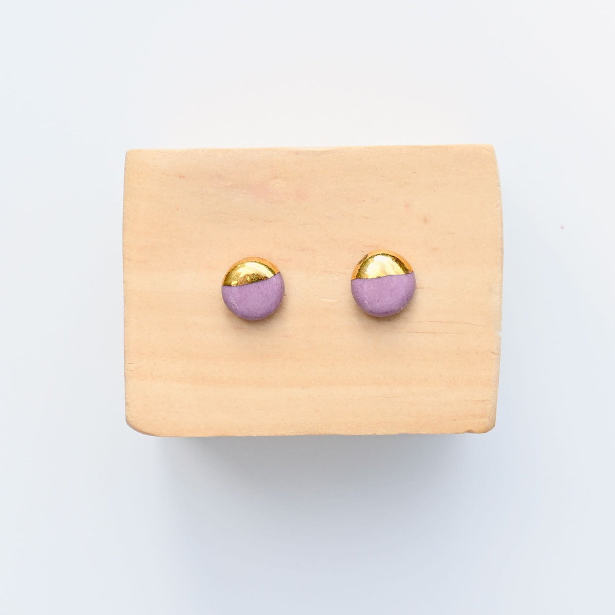 Handmade mauve porcelain stud earrings with gold luster by Hudson Ceramics