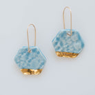 Light blue dangle earrings with gold accents
