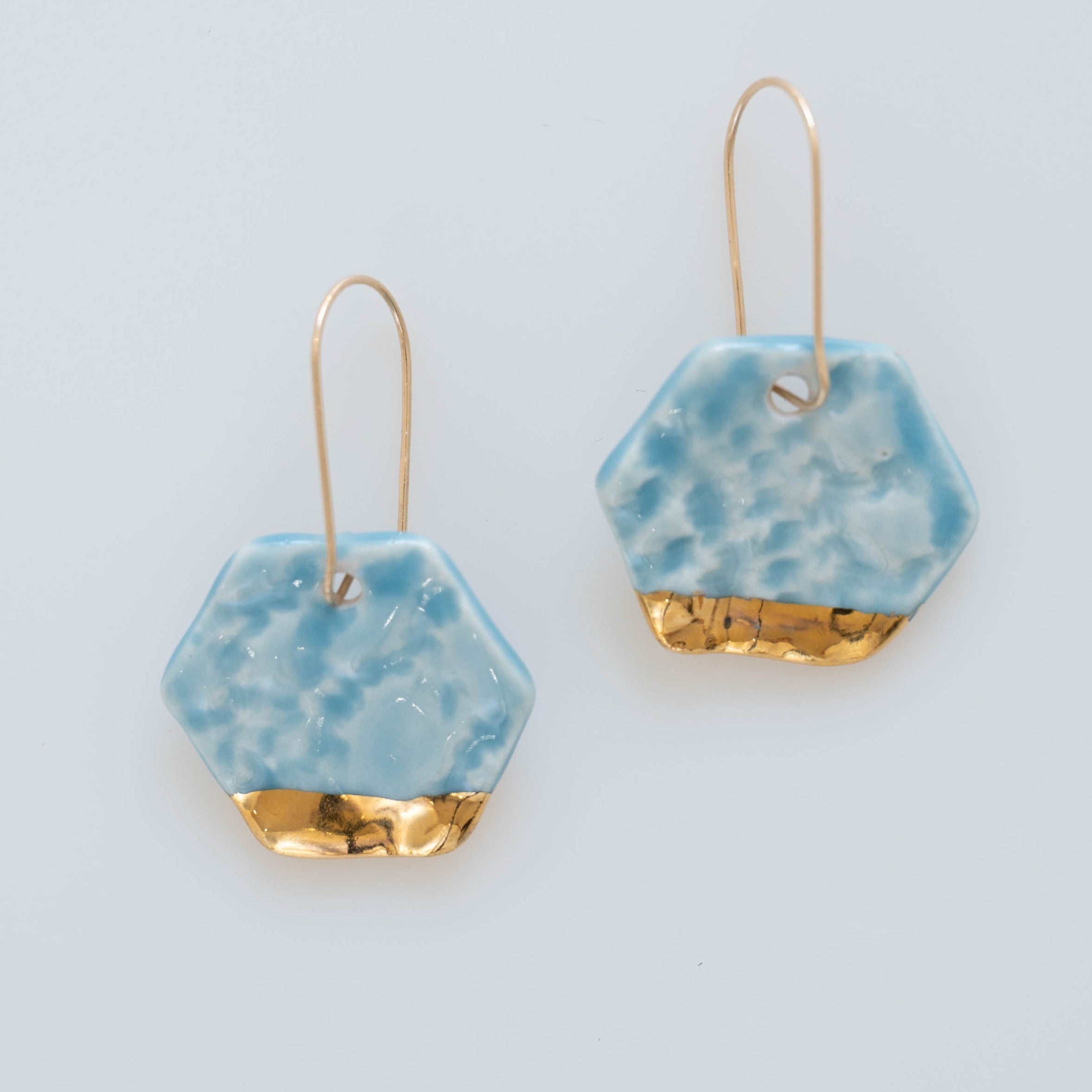Light blue dangle earrings with gold accents